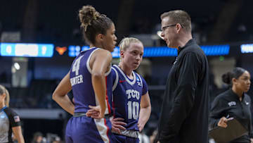 TCU Horned Frogs guards Donovyn Hunter and Hailey Van Lith talk to head coach Mark Campbell during the first half of an Elite 8.