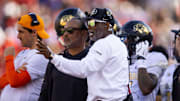 Oct 19, 2024; Tucson, Arizona, USA; Colorado Buffalos head coach Deion Sanders (right) with wide receivers coach Jason Phillips against the Arizona Wildcats at Arizona Stadium.