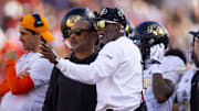 Oct 19, 2024; Tucson, Arizona, USA; Colorado Buffalos head coach Deion Sanders (right) with wide receivers coach Jason Phillips against the Arizona Wildcats at Arizona Stadium. Mandatory Credit: Mark J. Rebilas-Imagn Images