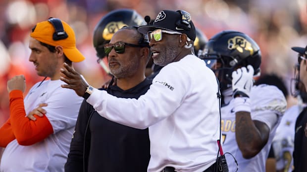 Colorado Buffalos head coach Deion Sanders (right) with wide receivers coach Jason Phillips against the Arizona Wildcats at A