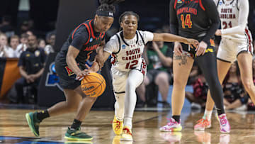 Mar 28, 2025; Birmingham, AL, USA; South Carolina Gamecocks guard MiLaysia Fulwiley (12) goes for a steal against Maryland Terrapins guard Sarah Te-Biasu (1) during the first half of a Sweet 16 NCAA Tournament basketball game at Legacy Arena. Mandatory Credit: Vasha Hunt-Imagn Images