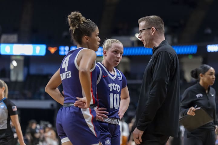 TCU Horned Frogs guards Donovyn Hunter and Hailey Van Lith talk to head coach Mark Campbell during the Elite 8.