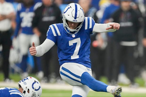 Indianapolis Colts kicker Matt Gay kicks a field goal in a blue jersey.