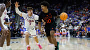 Nov 16, 2025; Jacksonville, Florida, USA; Florida Gators guard Urban Klavzar (7) defends Miami Hurricanes guard Tru Washington (10) during the second half at VyStar Veterans Memorial Arena. Mandatory Credit: Matt Pendleton-Imagn Images