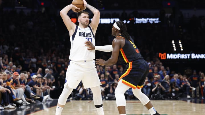 May 15, 2024; Oklahoma City, Oklahoma, USA; Oklahoma City Thunder guard Luguentz Dort (5) defends a pass by Dallas Mavericks guard Luka Doncic (77) during the second half of game five of the second round for the 2024 NBA playoffs at Paycom Center. Mandatory Credit: Alonzo Adams-USA TODAY Sports