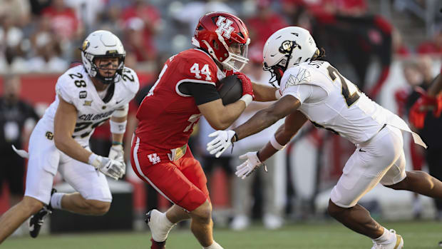 Houston Cougars running back Dean Connors (44) runs witht the ball as Colorado Buffaloes safety Carter Stoutmire (23) attempt