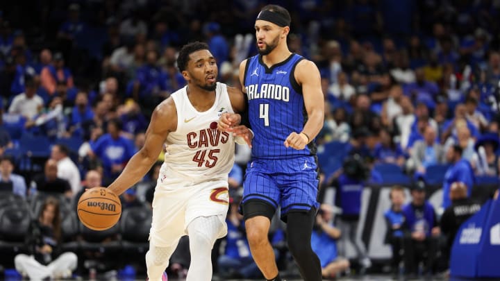 Apr 27, 2024; Orlando, Florida, USA; Orlando Magic guard Jalen Suggs (4) guards Cleveland Cavaliers guard Donovan Mitchell (45) in the third quarter during game four of the first round for the 2024 NBA playoffs at Kia Center. Mandatory Credit: Nathan Ray Seebeck-USA TODAY Sports