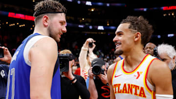 Former Dallas Mavericks star Luka Doncic #77 speaks with Trae Young #11 of the Atlanta Hawks.