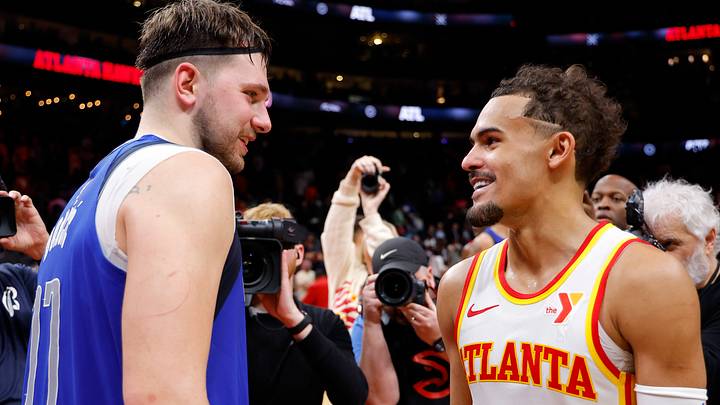 Former Dallas Mavericks star Luka Doncic #77 speaks with Trae Young #11 of the Atlanta Hawks.