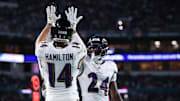 Oct 30, 2025; Miami Gardens, Florida, USA;  Baltimore Ravens safety Kyle Hamilton (14) and safety Malaki Starks (24) react after a play during the second quarter against the Miami Dolphins at Hard Rock Stadium. Mandatory Credit: Nathan Ray Seebeck-Imagn Images
