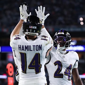 Oct 30, 2025; Miami Gardens, Florida, USA;  Baltimore Ravens safety Kyle Hamilton (14) and safety Malaki Starks (24) react after a play during the second quarter against the Miami Dolphins at Hard Rock Stadium. Mandatory Credit: Nathan Ray Seebeck-Imagn Images