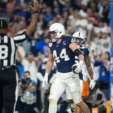 Dec 31, 2024; Glendale, AZ, USA; Penn State Nittany Lions tight end Tyler Warren (44) celebrates after scoring a touchdown against the Boise State Broncos in the Fiesta Bowl at State Farm Stadium. Mandatory Credit: Mark J. Rebilas-Imagn Images