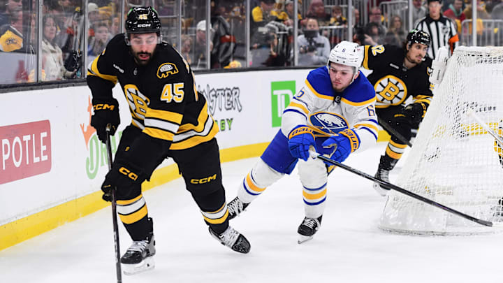 Apr 26, 2026; Boston, Massachusetts, USA;Boston Bruins defenseman Jonathan Aspirot (45) controls the puck from Buffalo Sabres left wing Zach Benson (6) during the second period in game four of the first round of the 2026 Stanley Cup Playoffs at TD Garden. Mandatory Credit: Bob DeChiara-Imagn Images