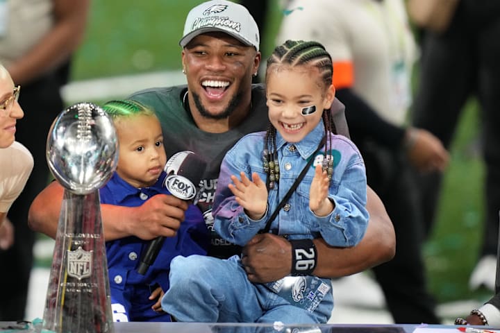 Philadelphia Eagles star Saquon Barkley talks to the media with his kids, Jada (right) and Saquon Jr. after Super Bowl LIX.