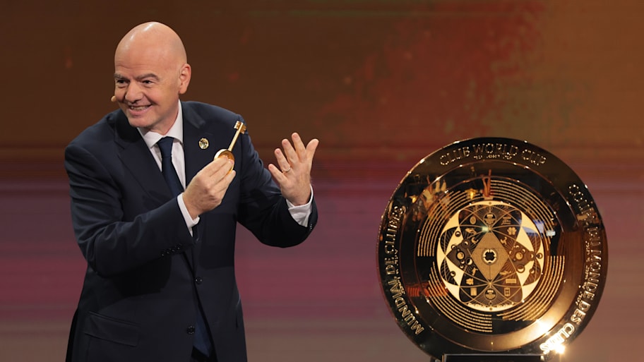 FIFA president Gianni Infantino presents the FIFA Club World Cup trophy during the tournament's draw.
