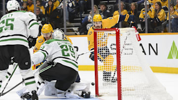 Apr 16, 2025; Nashville, Tennessee, USA;  Dallas Stars goaltender Jake Oettinger (29) blocks the shot of Nashville Predators left wing Filip Forsberg (9) during the first period at Bridgestone Arena. Mandatory Credit: Steve Roberts-Imagn Images