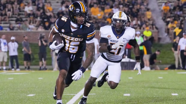 Missouri wide receiver Daniel Blood is chased by Murray State defensive back Jayson Coley chases.