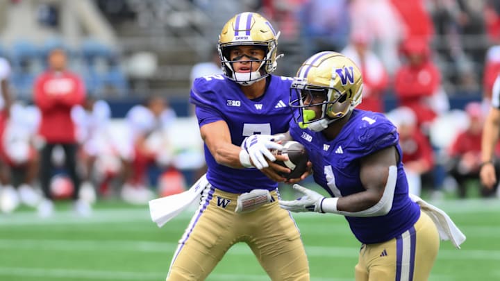 Sep 14, 2024; Seattle, Washington, USA; Washington Huskies quarterback Demond Williams Jr. (2) hands the ball off to Washington Huskies running back Jonah Coleman (1) during the second half at Lumen Field. Mandatory Credit: Steven Bisig-Imagn Images