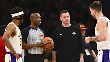 Mar 22, 2025; Los Angeles, California, USA; Los Angeles Lakers head coach JJ Redick, guard Jordan Goodwin (30), and guard Luka Doncic (77) speak with the ref against the Chicago Bulls during the second half at Crypto.com Arena. Mandatory Credit: Jonathan Hui-Imagn Images