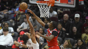 Oct 8, 2024; Cleveland, Ohio, USA; Chicago Bulls forward Julian Phillips (15) defends a shot by Cleveland Cavaliers forward Jaylon Tyson (24) in the fourth quarter at Rocket Mortgage FieldHouse. Mandatory Credit: David Richard-Imagn Images