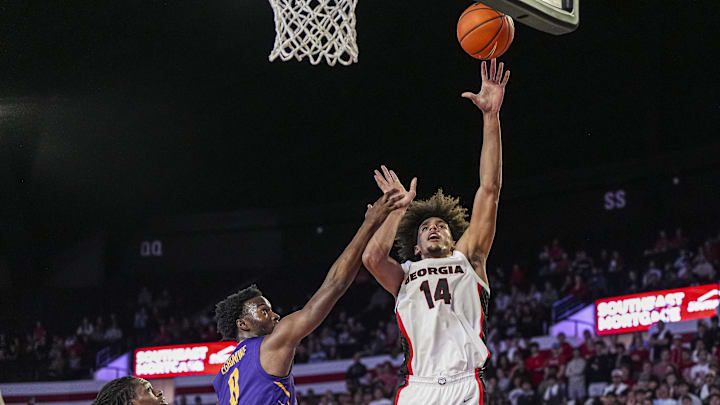 Nov 4, 2024; Athens, Georgia, USA; Georgia Bulldogs forward Asa Newell (14) shoots over Tennessee Tech Golden Eagles forward Ola Ajiboye (8) at Stegeman Coliseum. Mandatory Credit: Dale Zanine-Imagn Images