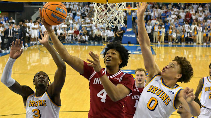 Jan 31, 2026; Los Angeles, California, USA;Indiana Hoosiers forward Sam Alexis (4) drives for a basket as he is defended by UCLA Bruins guard Eric Dailey Jr. (3) and guard Trent Perry (0) in the second half at Pauley Pavilion presented by Wescom Financial. Mandatory Credit: Jayne Kamin-Oncea-Imagn Images