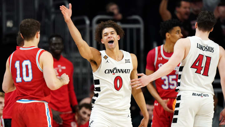 Cincinnati Bearcats guard Dan Skillings Jr. (0) gestures for possession in the second half of a college basketball game against the Bradley Braves during a second-round game of the National Invitation Tournament,, Saturday, March 23, 2024, at Fifth Third Arena in Cincinnati.