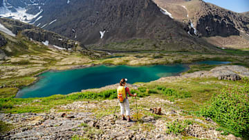 A backpacker enjoys the view in Chugach State Park near Anchorage, Alaska.