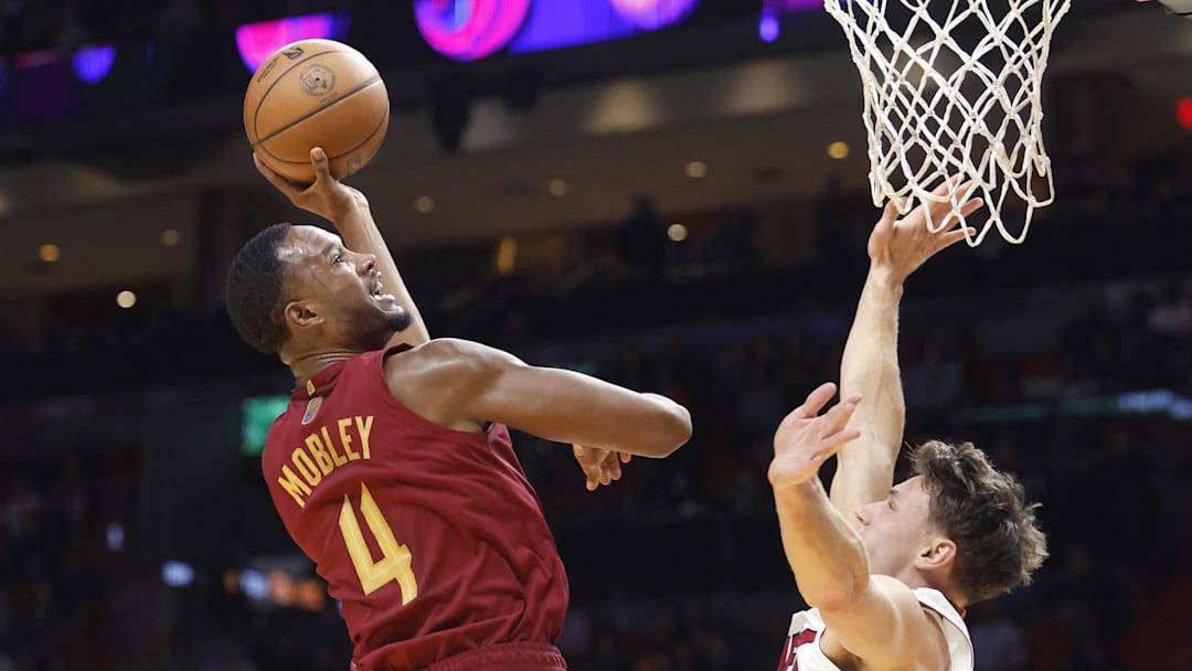 Nov 10, 2025; Miami, Florida, USA;  Cleveland Cavaliers center Evan Mobley (4) shoots over Miami Heat guard Pelle Larsson (9) during the first period at Kaseya Center. Mandatory Credit: Rhona Wise-Imagn Images