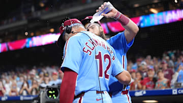 Aug 28, 2025; Philadelphia, Pennsylvania, USA; Philadelphia Phillies designated hitter Kyle Schwarber (12) is showered by outfielder Brandon Marsh (16) after the game against the Atlanta Braves at Citizens Bank Park. Mandatory Credit: Kyle Ross-Imagn Images