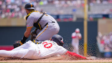 Jul 12, 2025; Minneapolis, Minnesota, USA; Minnesota Twins outfielder Willi Castro (50) slides home against the Pittsburgh Pirates in the second inning at Target Field. Mandatory Credit: Brad Rempel-Imagn Images