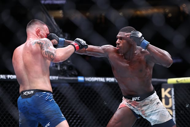 Colby Covington (red gloves) fights Joaquin Buckley (blue gloves) at Amalie Arena. 