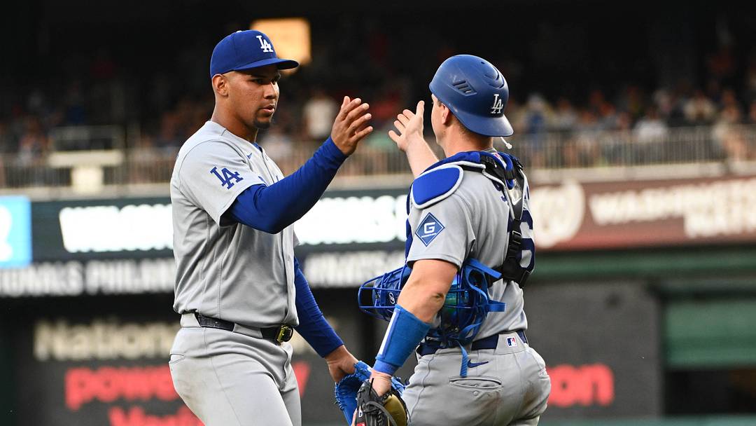 Apr 4, 2026; Washington, District of Columbia, USA; Los Angeles Dodgers pitcher Edgardo Henriquez (60) is congratulated by catcher Will Smith (16) after the final out against the Washington Nationals at Nationals Park. Mandatory Credit: Brad Mills-Imagn Images