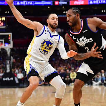 Los Angeles Clippers forward Kawhi Leonard (2) controls the ball against Golden State Warriors guard Stephen Curry (30) during the second half at Crypto.com Arena. Mandatory Credit: Gary A. Vasquez-Imagn Images