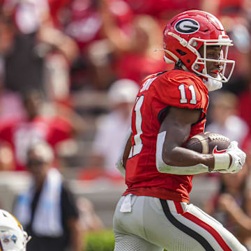 Sep 7, 2024; Athens, Georgia, USA; Georgia Bulldogs wide receiver Arian Smith (11) breaks a tackle to score a touchdown against the Tennessee Tech Golden Eagles during the second half at Sanford Stadium. Mandatory Credit: Dale Zanine-Imagn Images