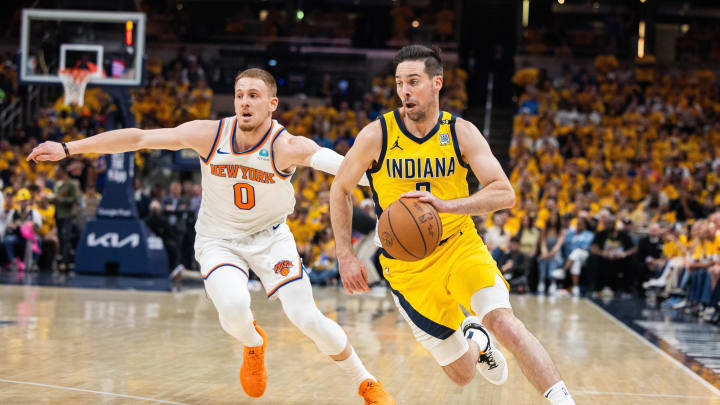 May 17, 2024; Indianapolis, Indiana, USA; Indiana Pacers guard T.J. McConnell (9) dribbles the ball while New York Knicks guard Donte DiVincenzo (0) defends during game six of the second round for the 2024 NBA playoffs at Gainbridge Fieldhouse. Mandatory Credit: Trevor Ruszkowski-USA TODAY Sports