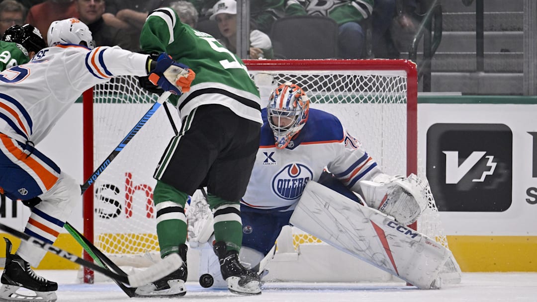 Nov 4, 2025; Dallas, Texas, USA; Edmonton Oilers goaltender Stuart Skinner (74) stops a shot by Dallas Stars center Wyatt Johnston (53) during the first period at the American Airlines Center. Mandatory Credit: Jerome Miron-Imagn Images
