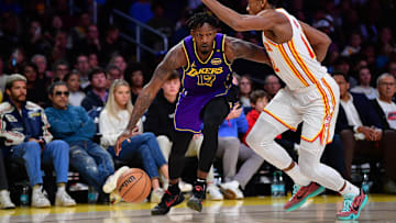 Jan 3, 2025; Los Angeles, California, USA; Los Angeles Lakers forward Dorian Finney-Smith (17) moves the ball against Atlanta Hawks forward De'Andre Hunter (12) during the second half at Crypto.com Arena. Mandatory Credit: Gary A. Vasquez-Imagn Images