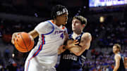Florida Gators forward Sam Alexis (4) posts up against North Florida Ospreys guard Nate Lliteras (2) during the second half at Exactech Arena at the Stephen C. O'Connell Center.