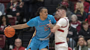 Jan 25, 2025; Stanford, California, USA;  Florida State Seminoles forward Malique Ewin (12) collides with Stanford Cardinal forward Maxime Raynaud (right) during the first half at Maples Pavilion. Mandatory Credit: Stan Szeto-Imagn Images