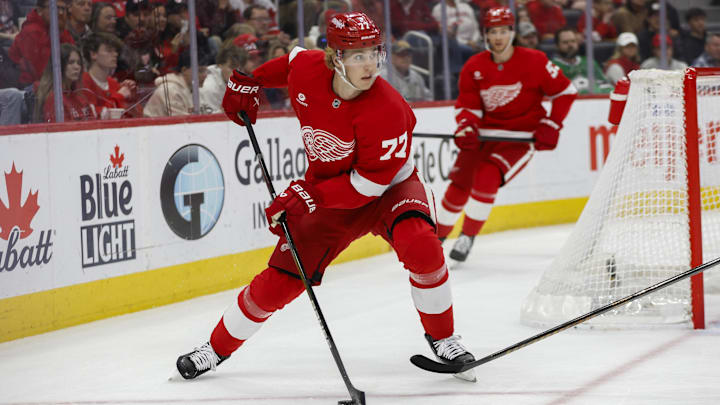 Apr 14, 2025; Detroit, Michigan, USA; Detroit Red Wings defenseman Simon Edvinsson (77) handles the puck during the first period against the Dallas Stars at Little Caesars Arena. Mandatory Credit: Brian Bradshaw Sevald-Imagn Images