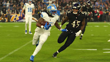 Sep 22, 2025; Baltimore, Maryland, USA; Detroit Lions running back Jahmyr Gibbs (0) rushes the ball past Baltimore Ravens linebacker Mike Green (45) during the first half at M&T Bank Stadium. Mandatory Credit: Mitch Stringer-Imagn Images