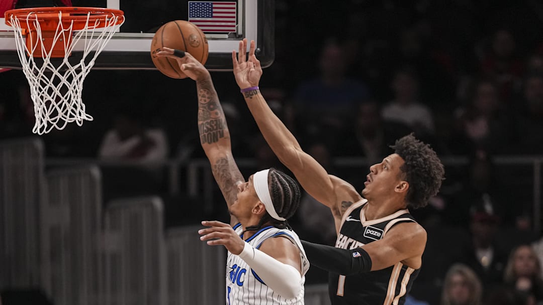 Mar 16, 2026; Atlanta, Georgia, USA; Atlanta Hawks forward Jalen Johnson (1) shoots defended by Orlando Magic forward Paolo Banchero (5) during the first half at State Farm Arena. Mandatory Credit: Dale Zanine-Imagn Images