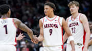 Mar 23, 2025; Seattle, WA, USA;  Arizona Wildcats guard Caleb Love (1) high-fives forward Carter Bryant (9) during a stop in play against the Oregon Ducks in the second half at Climate Pledge Arena. Mandatory Credit: Stephen Brashear-Imagn Images