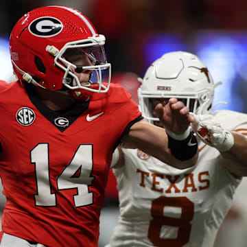 Dec 7, 2024; Atlanta, GA, USA; Georgia Bulldogs quarterback Gunner Stockton (14) drops back to pass against the Texas Longhorns during the second half in the 2024 SEC Championship game at Mercedes-Benz Stadium. Mandatory Credit: Brett Davis-Imagn Images
