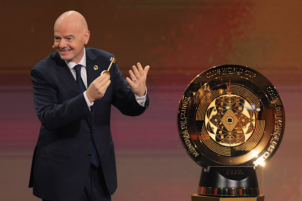 FIFA president Gianni Infantino presents the FIFA Club World Cup trophy.