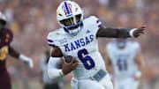 Kansas Jayhawks quarterback Jalon Daniels (6) scrambles in for a touchdown.