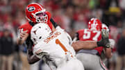 Nov 15, 2025; Athens, Georgia, USA; Texas Longhorns defensive end Colin Simmons (1) tackles Georgia Bulldogs quarterback Gunner Stockton (14) in the second half at Sanford Stadium. Mandatory Credit: Dale Zanine-Imagn Images