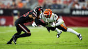 Oct 8, 2023; Glendale, Arizona, USA; Cincinnati Bengals wide receiver Tyler Boyd (83) dives for yardage as he is tackled by Arizona Cardinals cornerback Marco Wilson (20) in the second half at State Farm Stadium. Mandatory Credit: Mark J. Rebilas-Imagn Images