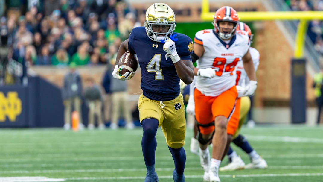 Nov 22, 2025; South Bend, Indiana, USA; Notre Dame Fighting Irish running back Jeremiyah Love (4) runs for a touchdown against the Syracuse Orange during the first half at Notre Dame Stadium. Mandatory Credit: Michael Caterina-Imagn Images